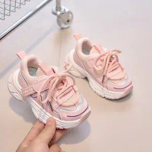 Detail showing pink mesh upper and thick white rubber sole of children sports sneakers