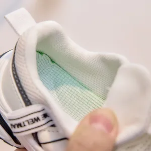 Macro detail of breathable plaid lining and padded heel collar on kids' sneakers