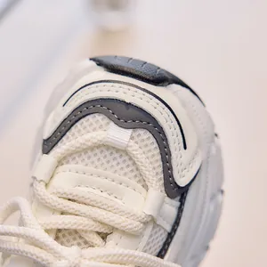 Close-up of breathable mesh fabric and durable synthetic leather stitching on kids sneakers