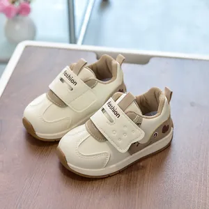 Detailed top view of toddler sneakers with velcro straps and cute cartoon bear pattern