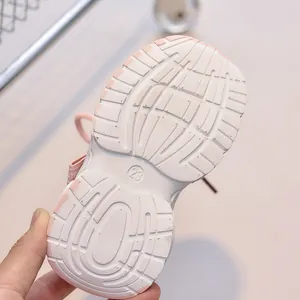 Detail of size 23 anti-slip EVA sole on breathable children sneakers in pink and white