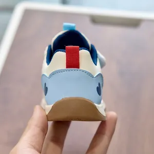 Detailed back view of toddler sneakers featuring a blue heart patch and red heel pull tab