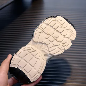 Detailed view of durable rubber outsole with size 28 stamp and non-slip traction pattern