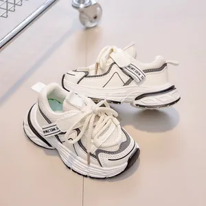 Detail view of breathable mesh upper and anti-slip sole on white children's chunky sneakers