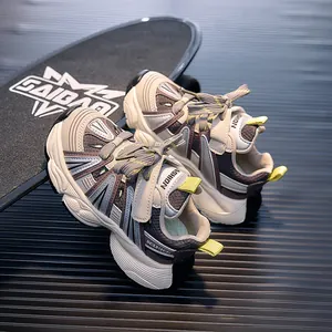 Detail of kids breathable sneakers with leather mesh panels and neon green pull tabs