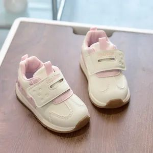 Detail of toddler sports shoes with velcro strap and pink fashion leather upper