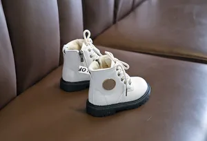 Detail of white kids leather boots featuring soft plush lining and side zipper closure