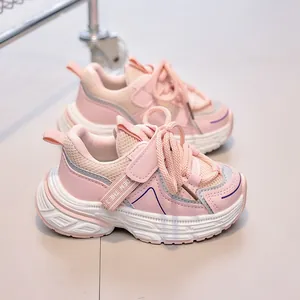 Detail of breathable pink mesh and durable Velcro strap on children sports shoes