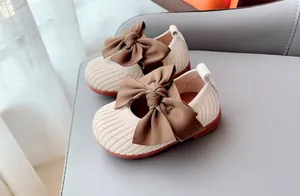 Detail of baby girl Mary Jane shoes with bow decoration and breathable knit material