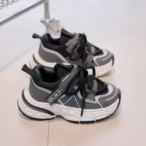 Detail view of children's mesh sneakers with breathable grey and black splicing patterns