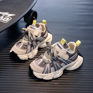 Detail of children's mesh sneakers featuring grey patchwork design and thick anti-slip soles