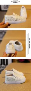 Detail view of silver sequin toddler slip-on shoes with thick LED glowing soles