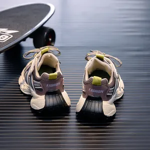Detail view of children's mesh sneakers with thick wavy rubber soles and fashion lettering