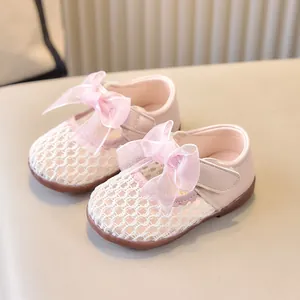 Détail de chaussures roses pour bébé avec maille respirante et décoration nœud mignon