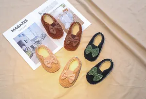 Detailed view of plush lamb wool toddler moccasins with cute polka dot bows in three colors