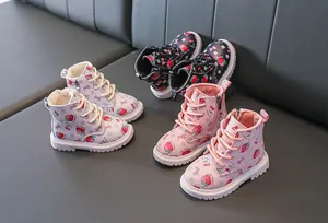 Detail of plush lining and strawberry prints on children's leather boots with zippers