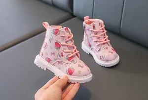 Detail of pink toddler boots with strawberry prints and a convenient side zipper closure