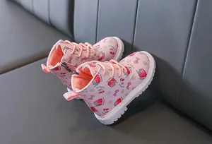 Detailed side view of pink toddler boots featuring cute strawberry and floral patterns