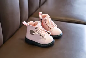 Detail of pink kids' martin boots showing warm fleece lining and side zipper closure