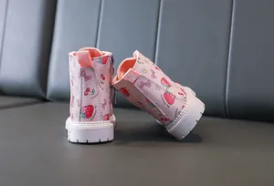 Detail view of pink strawberry print toddler boots with side zipper and thick rubber sole