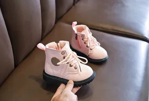 Detail view of pink toddler winter boots with warm plush lining and side zipper closure