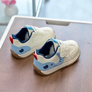 Detailed close-up of toddler sneakers with cream leather finish and blue heart pattern