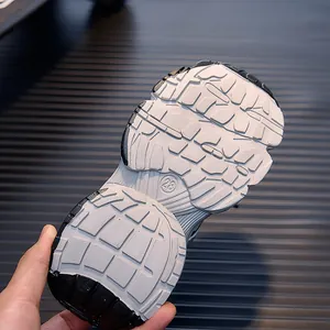 Close-up of kids sneaker sole with anti-slip rubber texture and size 28 engraving