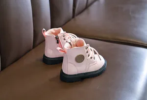 Detail of pink kids' leather boots with side zipper and sturdy non-slip rubber soles