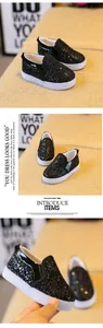 Detailed view of kids black sequin slip-on shoes with thick white anti-slip soles