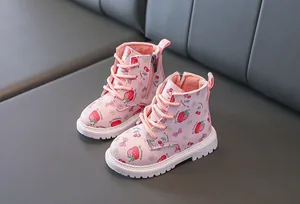 Detail view of pink girl's boots with strawberry print and soft plush warm lining