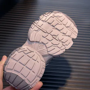 Close-up of pink non-slip rubber sole with grip pattern and size 28 engraving
