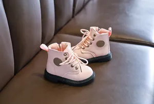 Detail of pink kids boots with warm plush lining and side zipper for easy wear