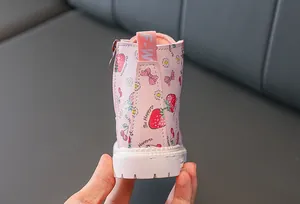 Detail of pink toddler boots featuring cute strawberry prints and a side zipper closure