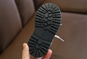 Close-up of durable black rubber anti-slip sole for children's boots with size 22 mark