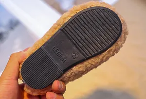 Detail of baby plush winter shoe featuring anti-slip rubber sole with Lemon logo