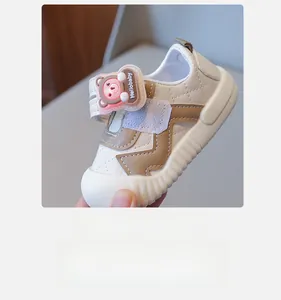 Detail of baby soft-sole walking shoes with velcro straps and cute bear decoration