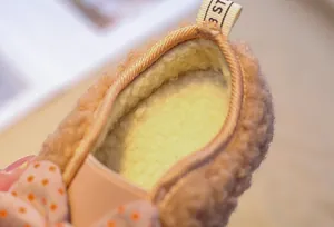 Close-up of soft lamb wool lining and plush interior on girls winter thermal loafers
