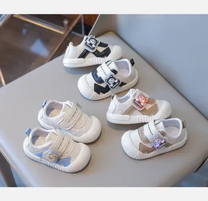 Detail of infant walking shoes featuring bear velcro straps and anti-kick toe design