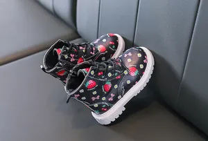 Detail of toddler boots with strawberry patterns, side zipper, and anti-slip rubber soles