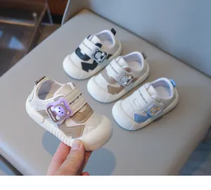 Detailed view of baby walking shoes with protective toe caps and cartoon bear straps