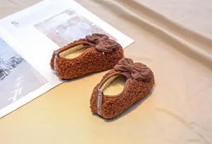 Detailed view of plush baby loafers with brown teddy fleece and polka dot bow