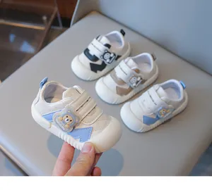 Detailed view of baby walking shoes with cartoon bear straps and non-slip rubber soles