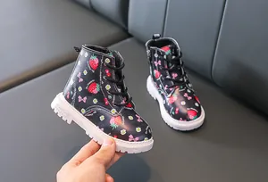Detail view of toddler boots featuring strawberry print and side zipper closure