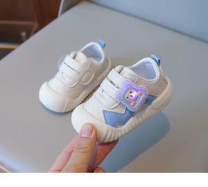Detail of baby light-up shoe with LED bear motif and double velcro strap closure
