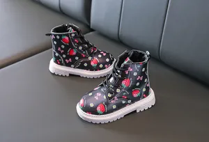 Detailed view of kids strawberry print black boots with thick white anti-slip soles