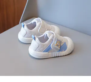 Detailed side view of baby walking shoes with cartoon bear and velcro strap closure