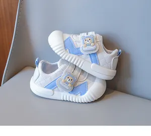 Detailed side view of baby walking shoes with blue cartoon bear and velcro closure