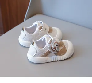Detailed view of baby walking shoes with quilted faux leather and cute bear charm