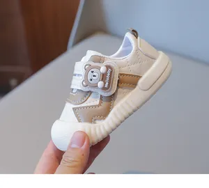 Detailed side view of toddler anti-collision shoes with cute 3D cartoon bear decoration
