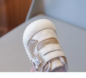 Detail of toddler shoe with reinforced rubber toe cap and cute 3D silicone bear